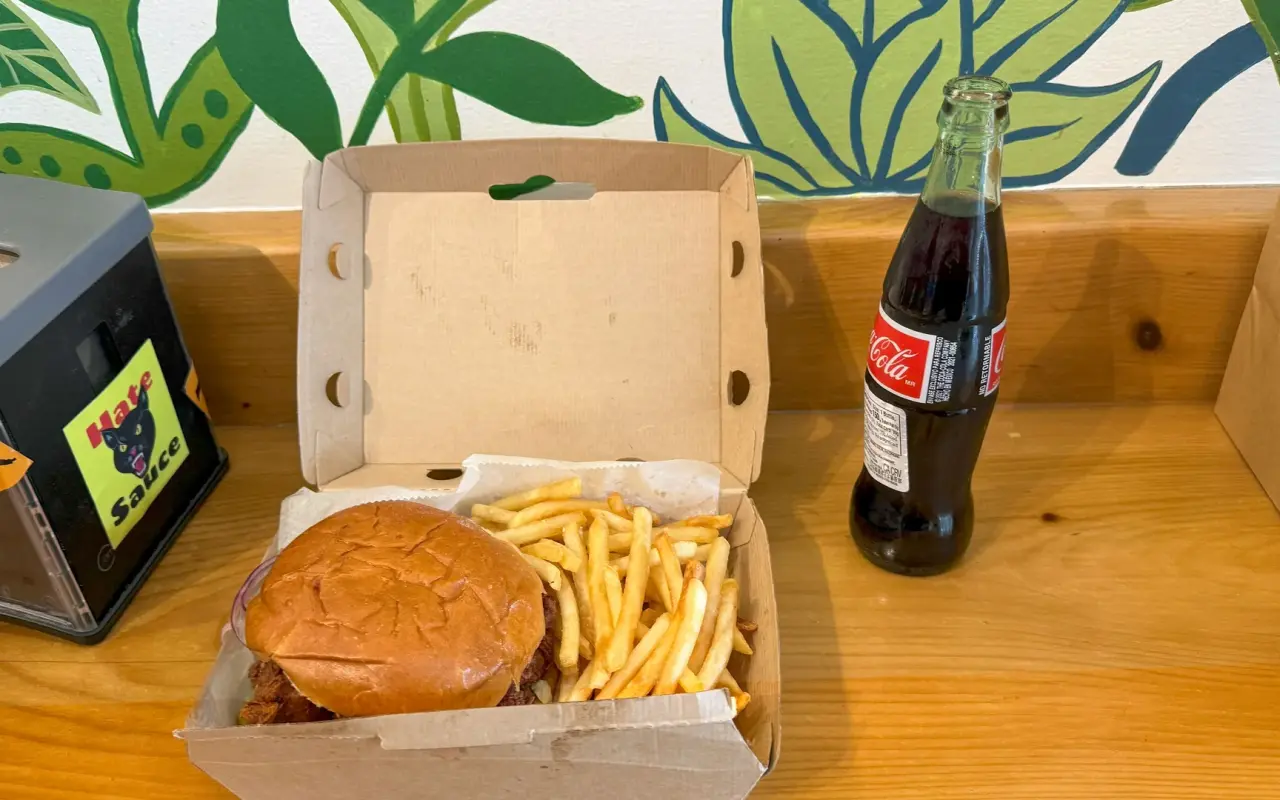 Fried chicken sandwich with fries and a glass bottle of Coca-Cola at TigerHawk Sandwich Co in Oak Bluffs