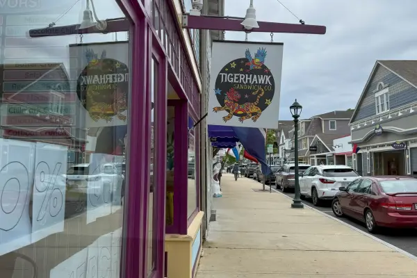 Tigerhawk Sandwich Co. sign over the Circuit Avenue sidewalk