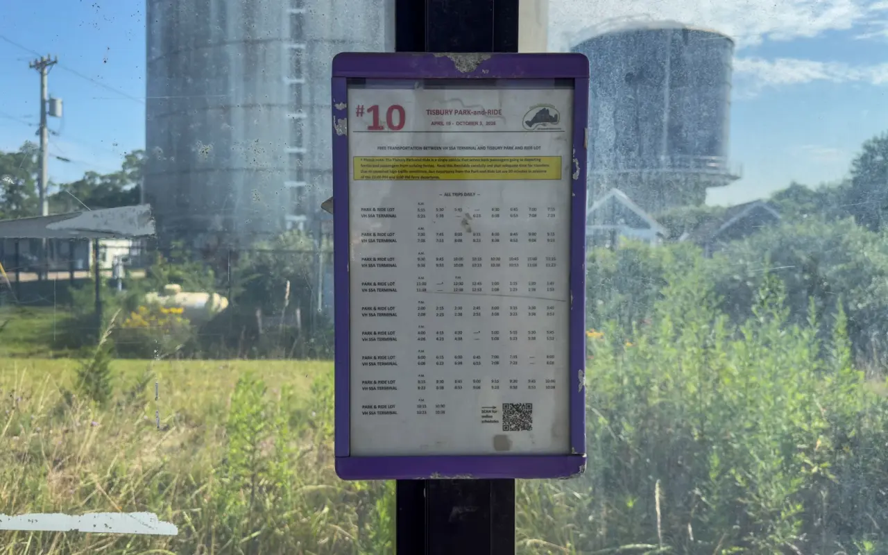 Bus stop sign with a Route 10 timetable at the Tisbury park-and-ride lot