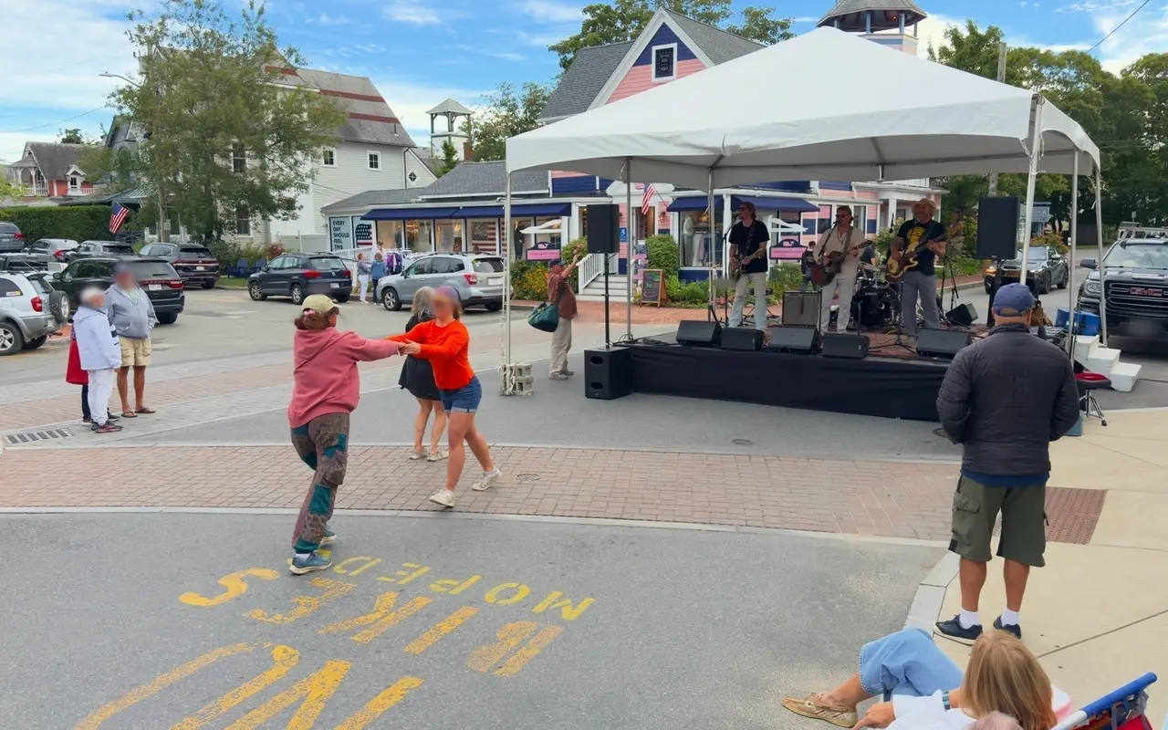 People dancing in the closed street in front of a band tent on Circuit Avenue during Tivoli Day