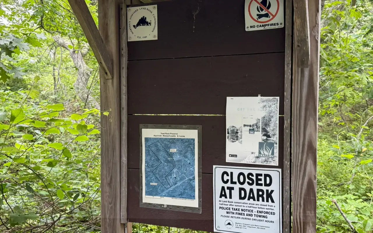 Trailhead kiosk with map and closed-at-dark sign at Toad Rock Preserve