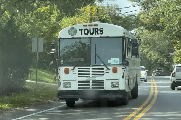 A Martha's Vineyard Sightseeing tour bus on a Vineyard Haven road
