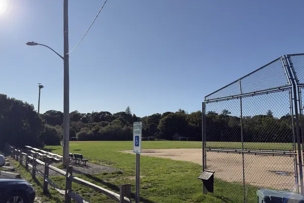 Veterans Memorial Park: bleachers, the ball field and the flag on a September morning