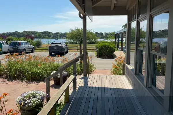 Shop porch and daylilies overlooking the water off Beach Road