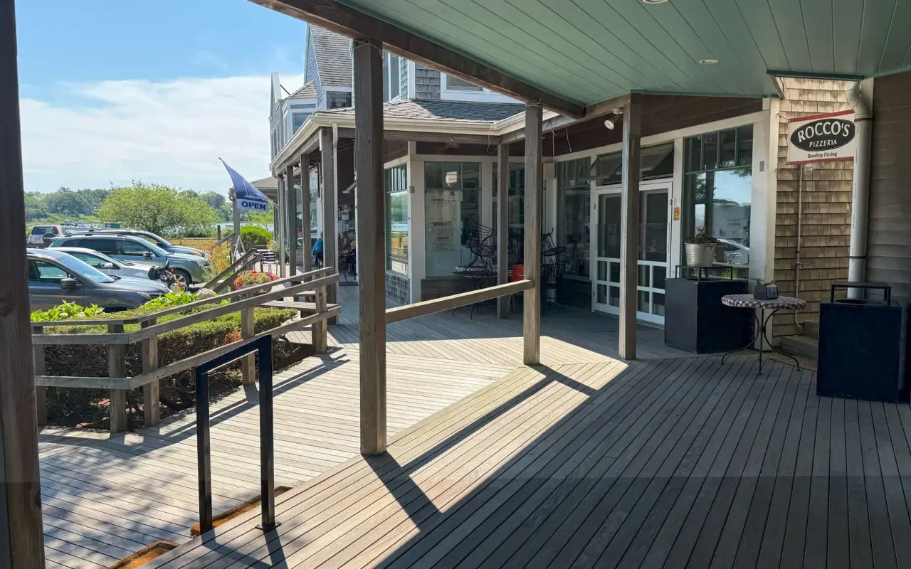 A covered wooden deck along a row of shops on Beach Road in Vineyard Haven