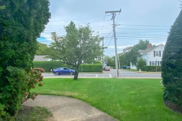 Hedged lawn and white clapboard house on a Vineyard Haven corner