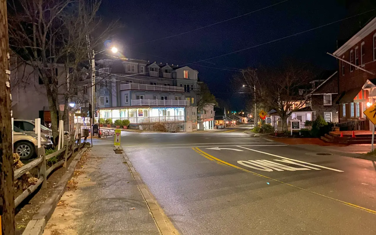 Main Street in Vineyard Haven at night with lit storefronts and no traffic