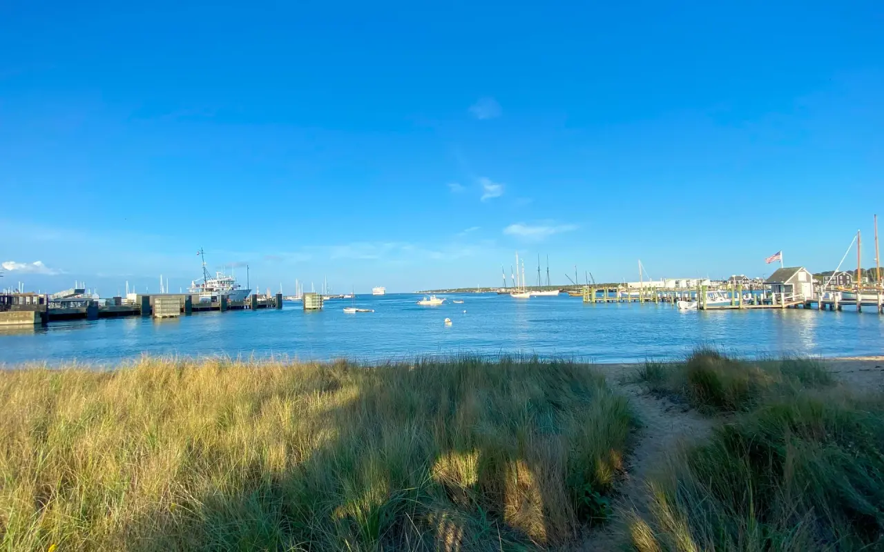 Vineyard Haven harbour at evening with moored sailboats and the ferry dock