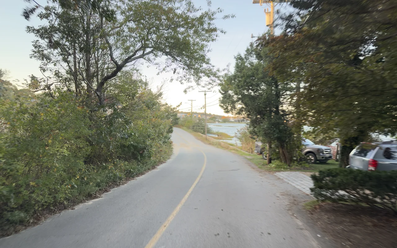 A quiet lane near the museum, water through the trees