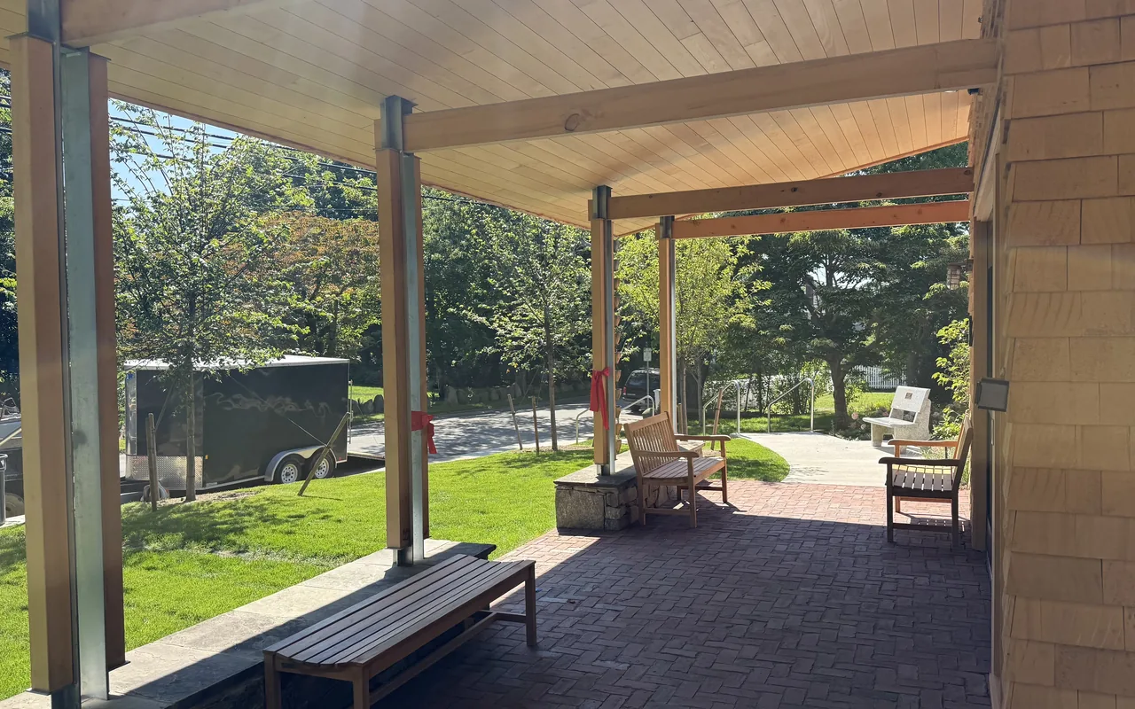 The new covered porch of the Vineyard Haven Public Library with benches, looking toward Main Street
