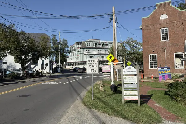 State Road toward the Mansion House, with the Give 4 Ft to Pass sign and the brick Educomp building