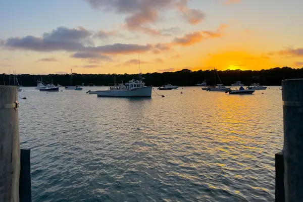 Sunset over moored boats from the Lake Tashmoo dock