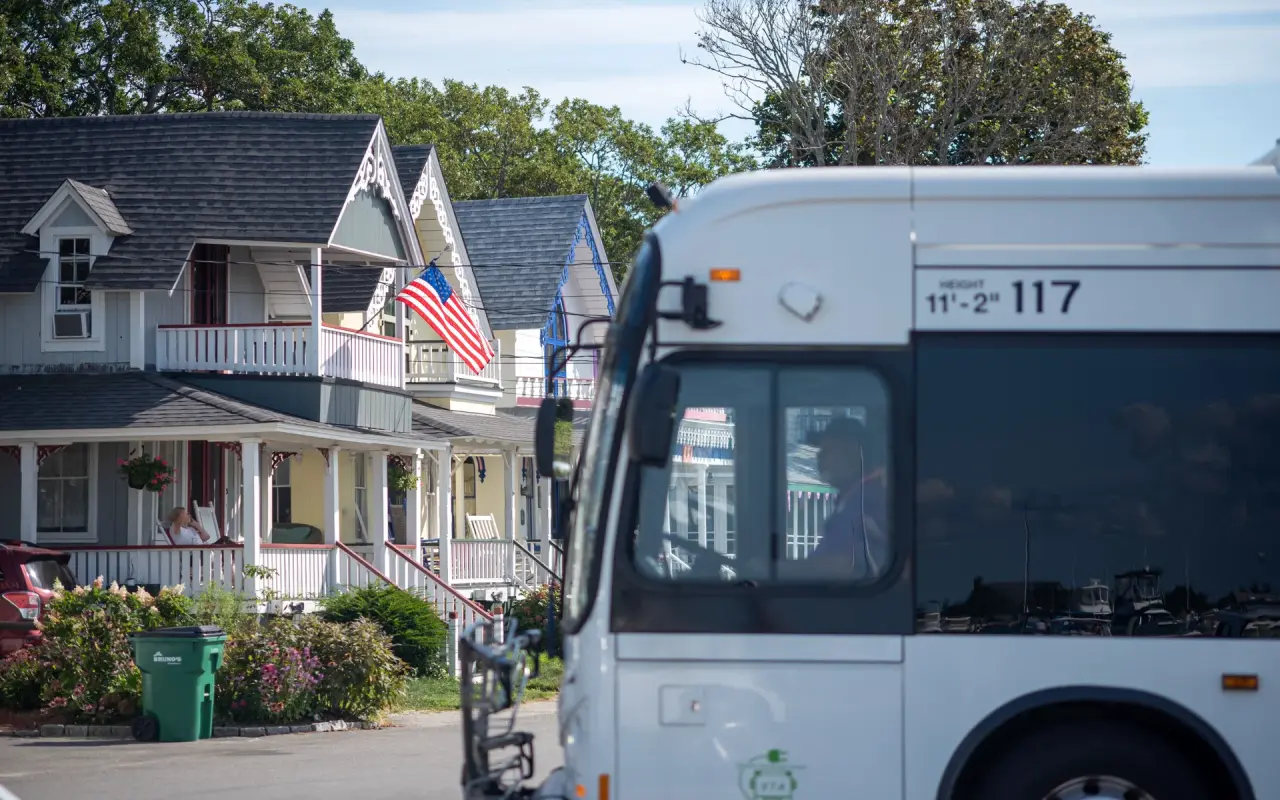 VTA bus passing gingerbread cottages in Oak Bluffs in summer