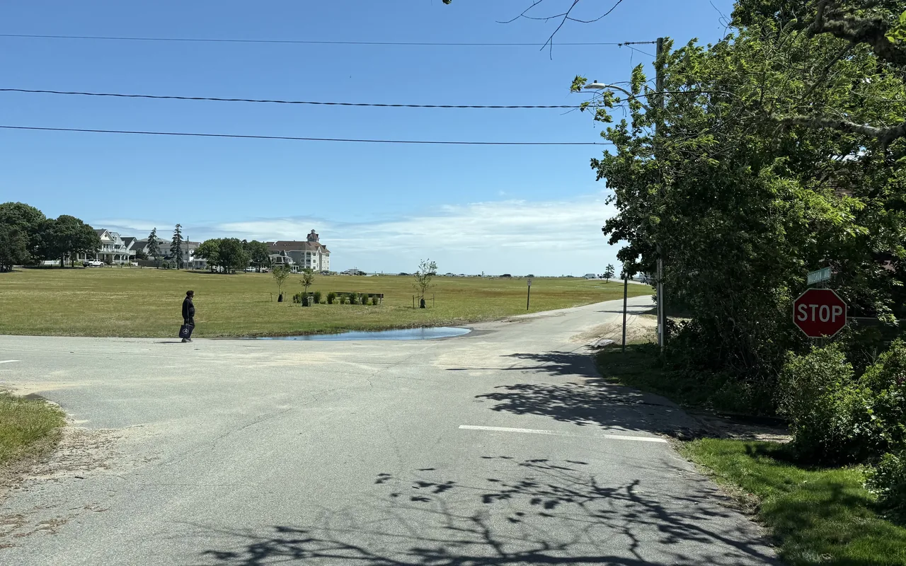 Open lawn of Waban Park in Oak Bluffs with houses and the sea in the distance