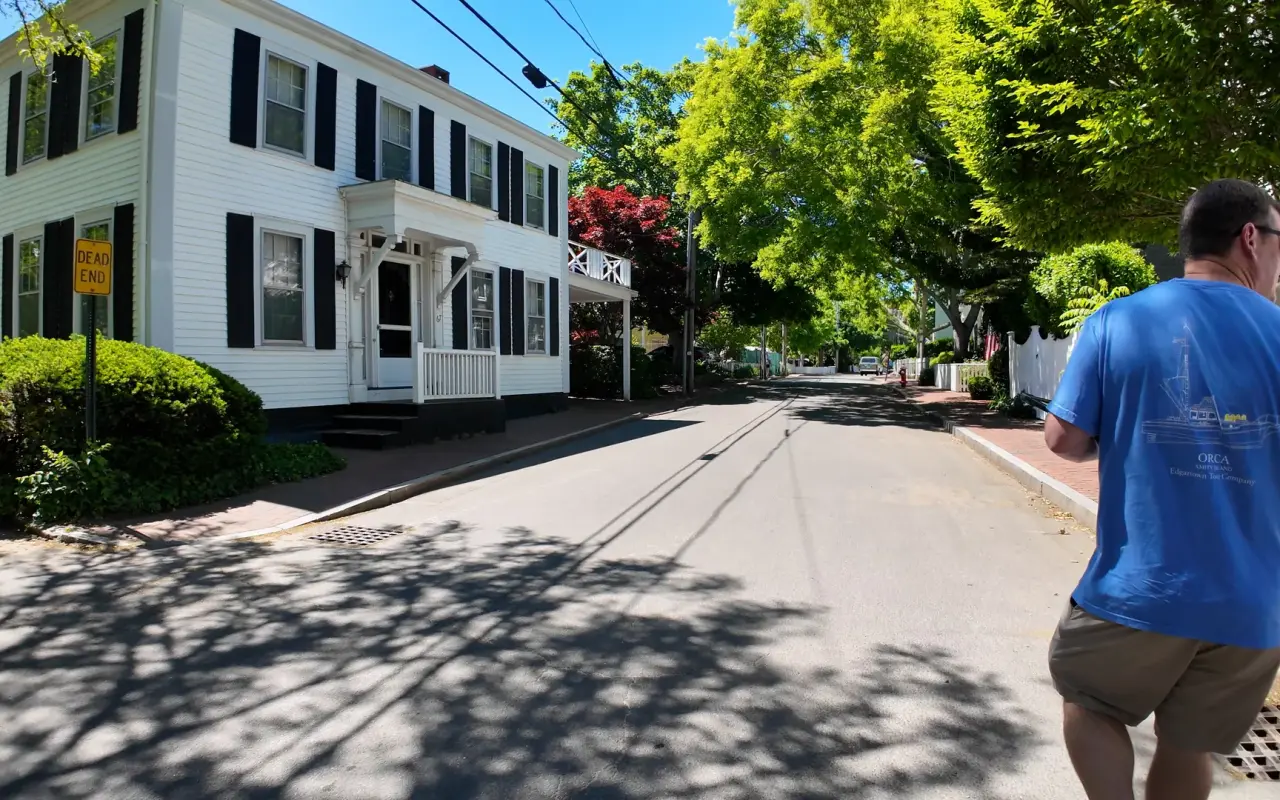 Mike Currid leading a walking tour past a historic captain's house in Edgartown, Martha's Vineyard