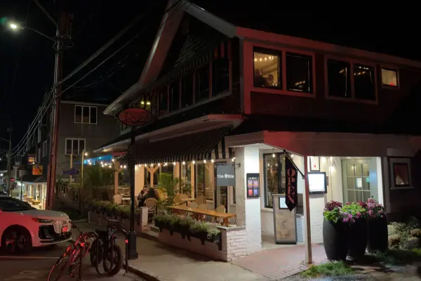 Waterside Market and The Attic lit up after dark on Main Street.