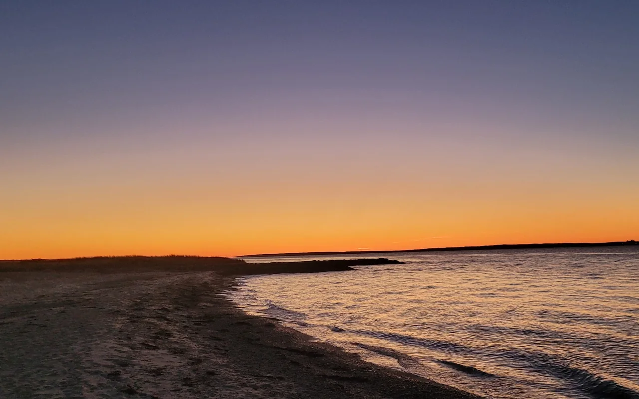 West Chop after sunset, a low stone jetty and the sky going from orange to violet