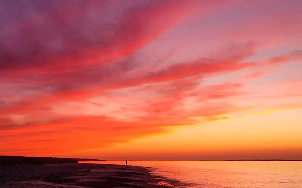 Red and orange sunset sky over the water at West Chop