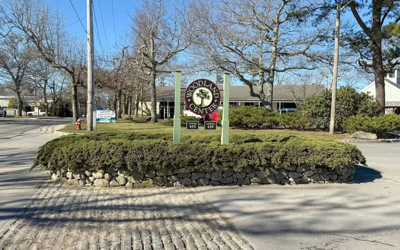 The Woodland Center entrance sign on a stone wall on State Road in Vineyard Haven