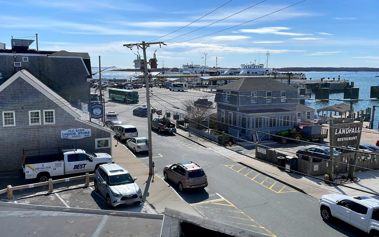 Water Street in Woods Hole seen from above with shops along the left and the harbor on the right