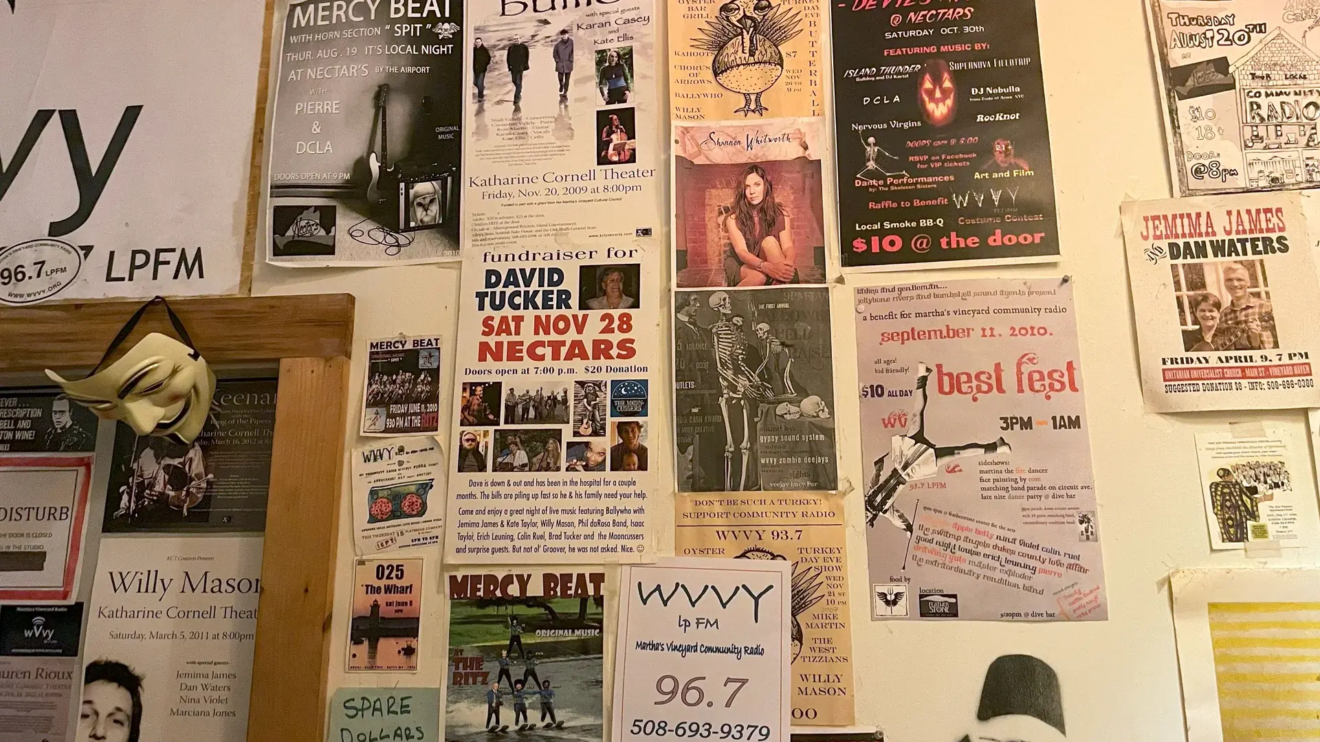 Gig posters covering the studio wall at WVVY-LP 96.7 FM