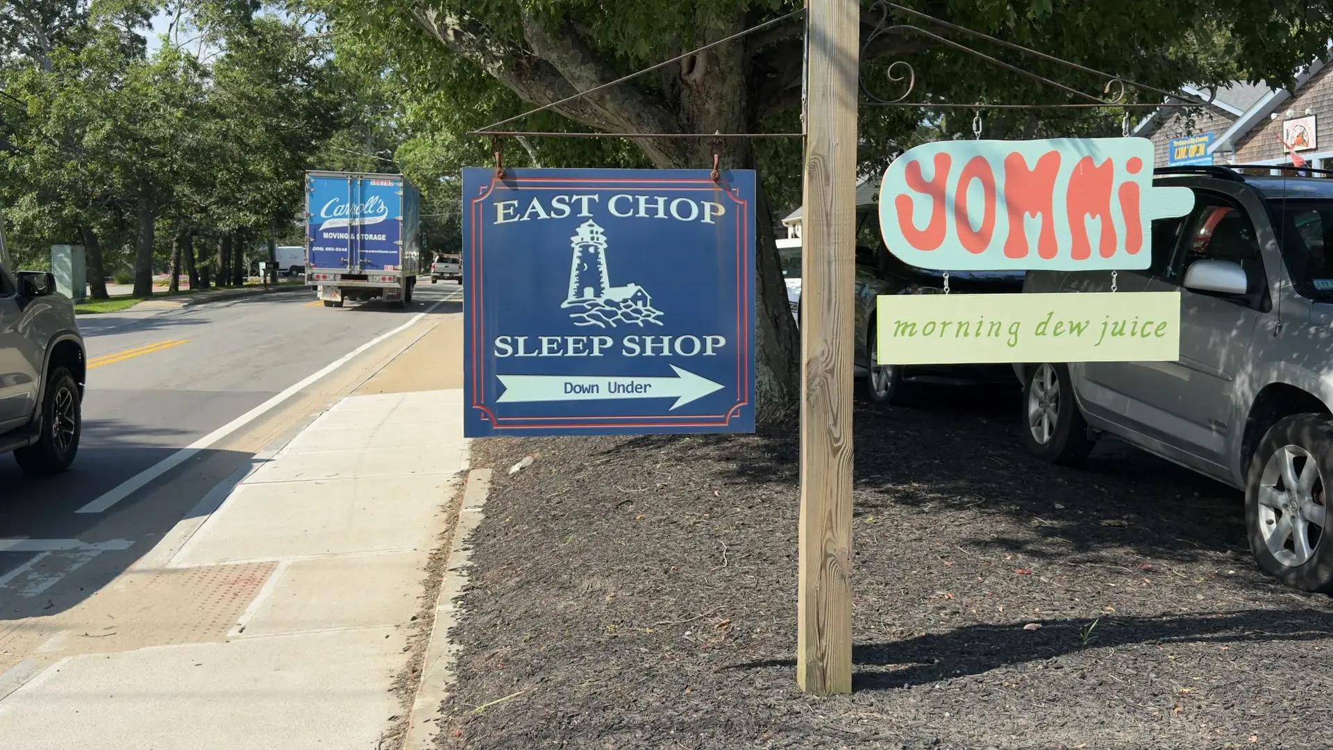 Signs for Yommi and Morning Dew Juice sharing the roadside in Vineyard Haven