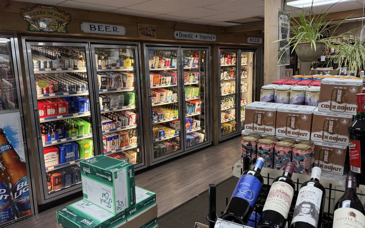Beer coolers and stacked craft beer cases inside Your Market at the Triangle