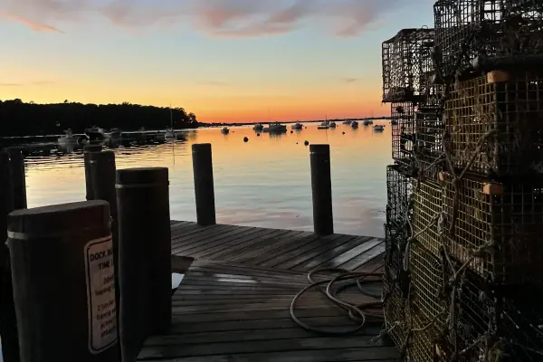 Lobster traps stacked on the dock at dusk