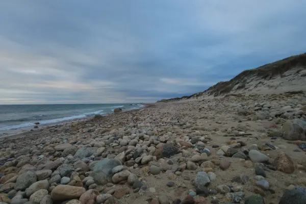 Rocky shoreline beneath a sandy bluff at Cedar Tree Neck