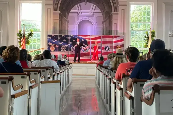 Audience watching a performance inside the Old Whaling Church