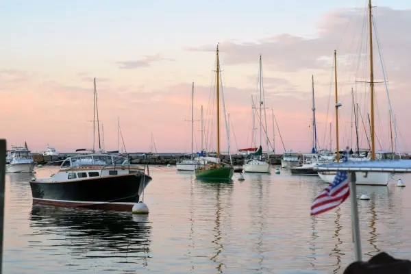 Boats moored across Vineyard Haven harbor in evening light