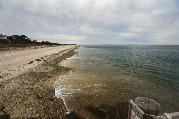 Waves rolling onto a quiet Vineyard Haven beach on an overcast day